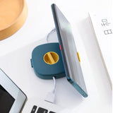 Enhanced Product Title: "2-in-1 Kabelaufroller mit integriertem Telefonständer – Kompakt & Tragbar für unterwegs" 

This title maintains the original product features while adding keywords like "tragbar" (portable) to attract more potential customers sear