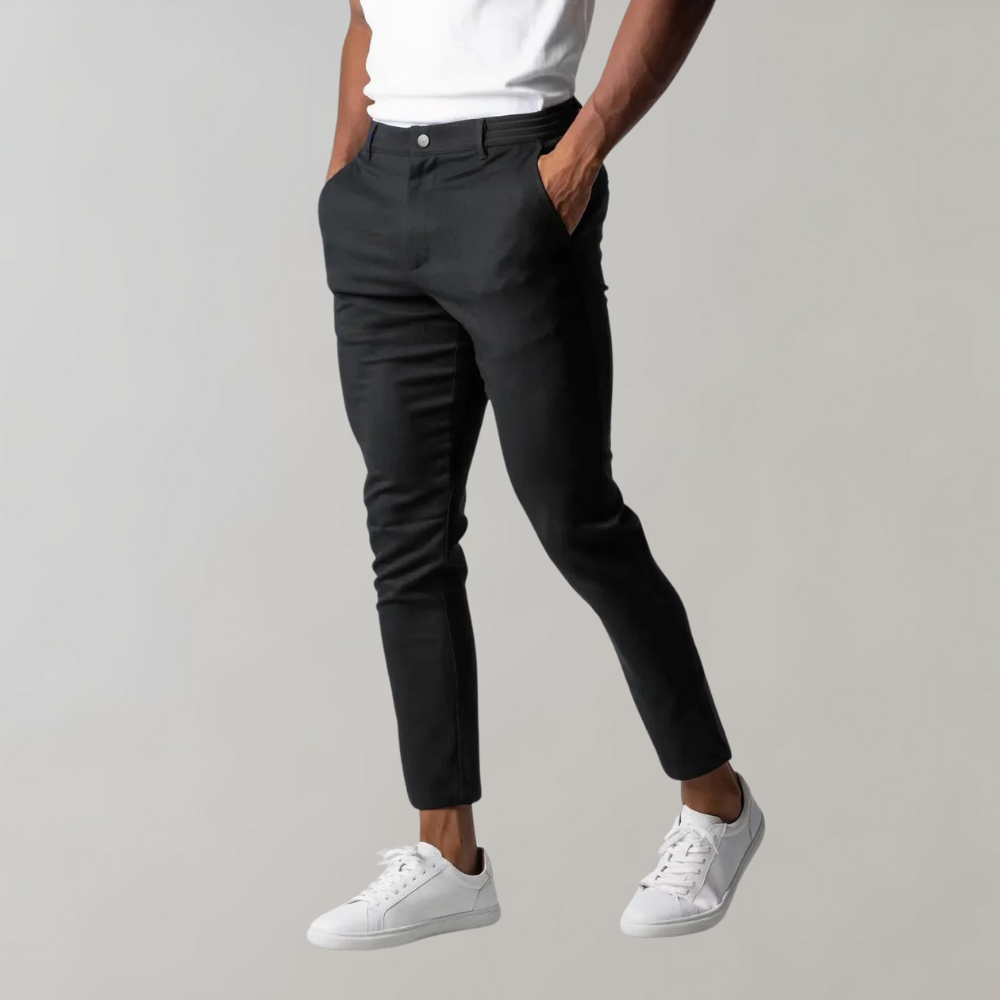 Black chino pants for men, slim fit, cotton, elegant, modern, with white sneakers.