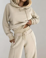 Woman in beige hoodie and jogger pants, casual fashion, comfortable women's clothing, streetwear.