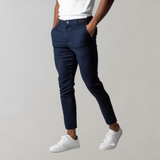 Man wearing dark blue chino pants, white sneakers, casual style, men's fashion.