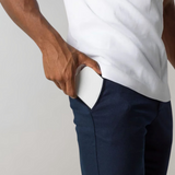 Man putting a white smartphone in a blue pants pocket, technology, mobile device, everyday scene.